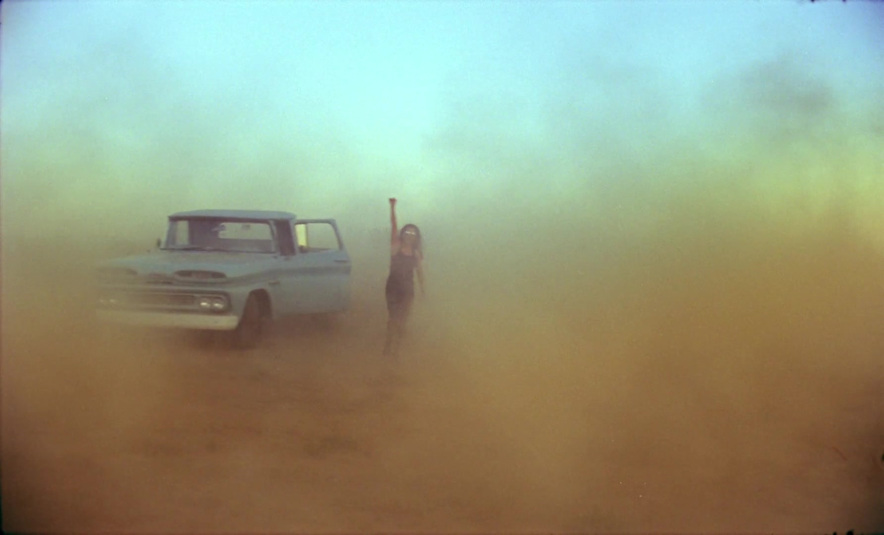 Planetarium — Woman and pickup in colored dust