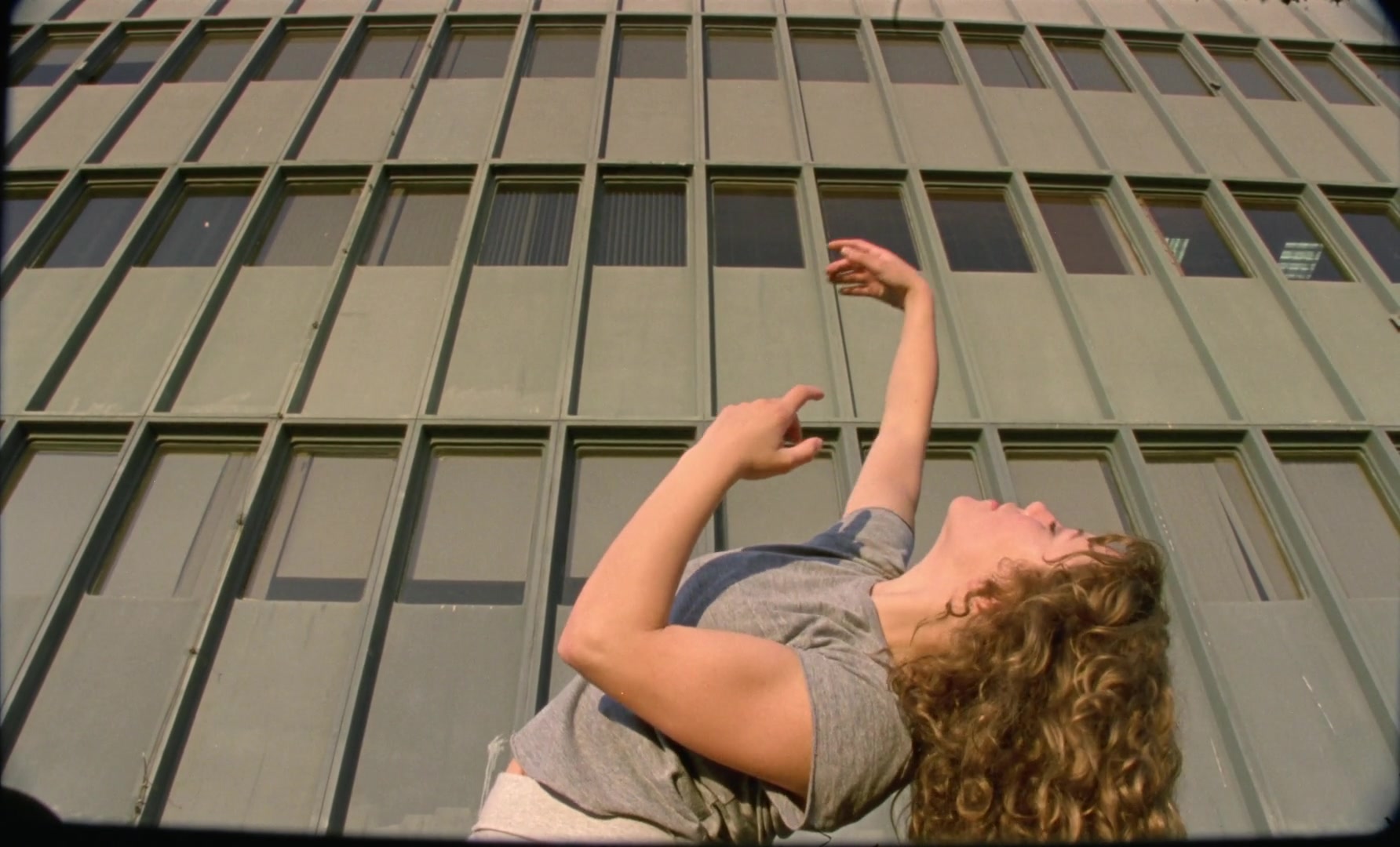 Planetarium — Dancer against an office building